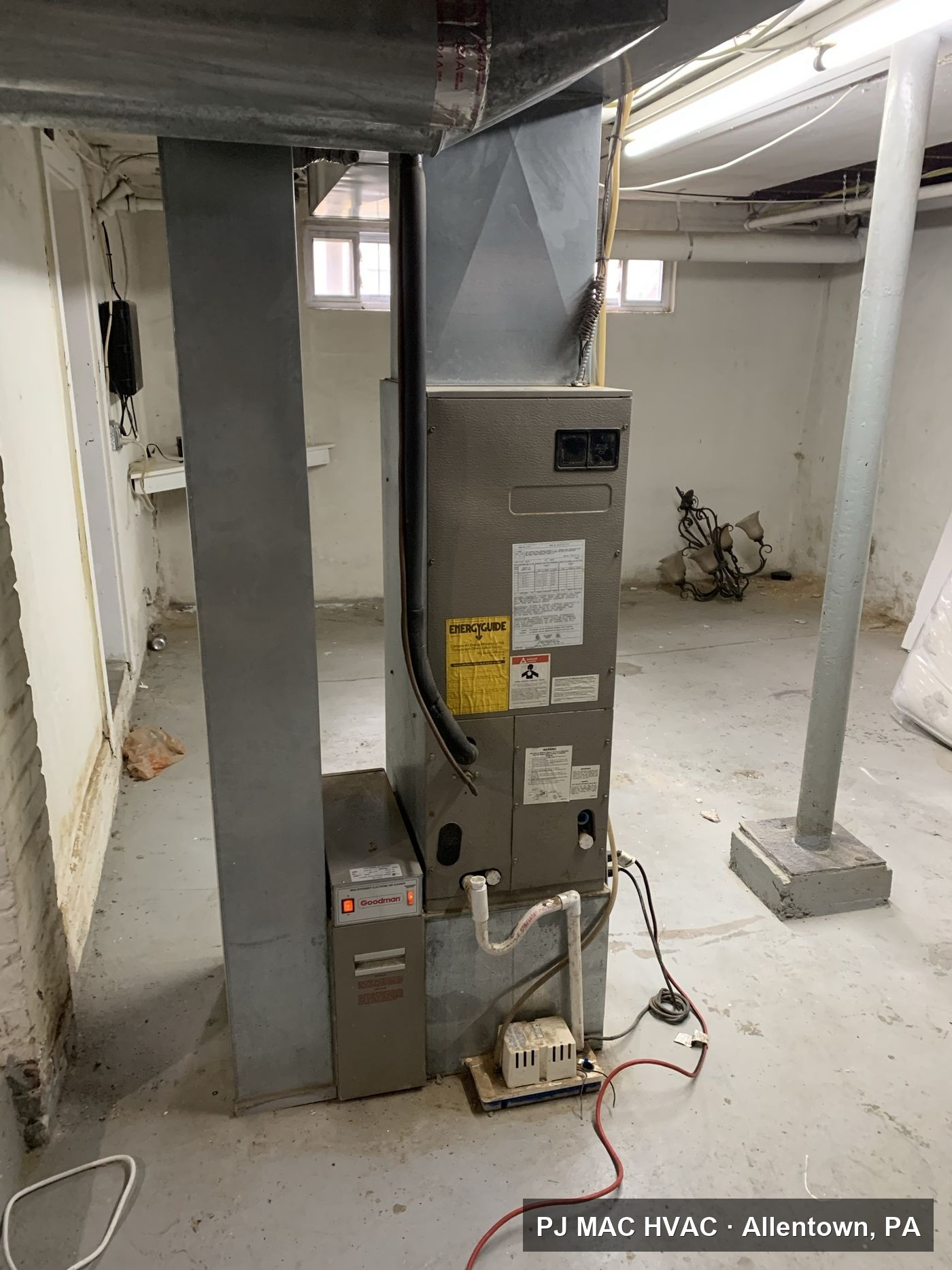 A basement air handler and ductwork installed by PJ MAC HVAC.