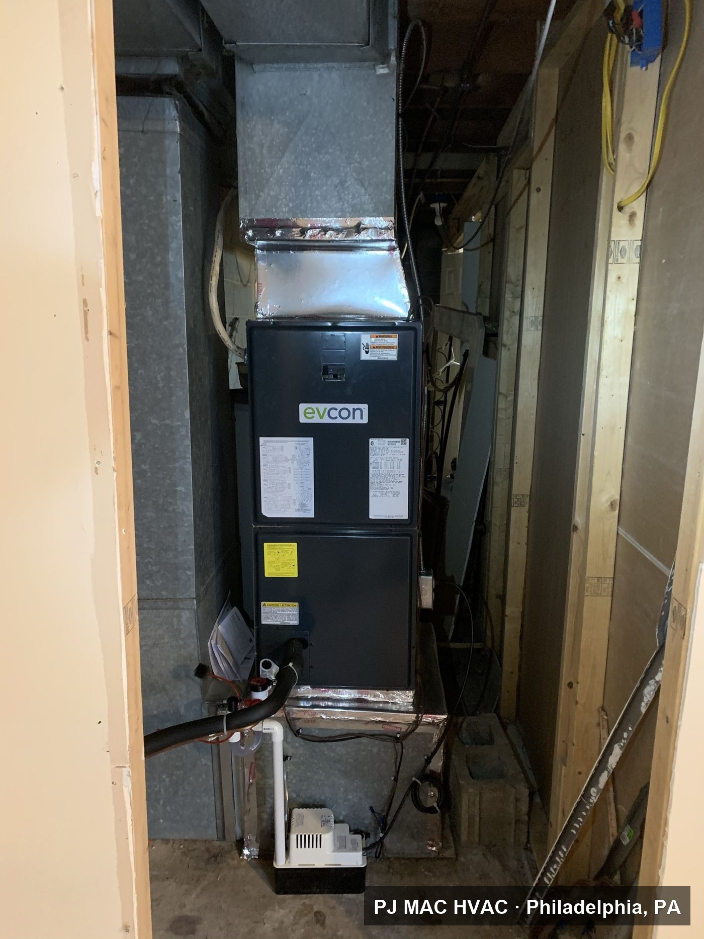 A new Evcon air handler with condensate pump installed by PJ MAC HVAC in a tight basement space.