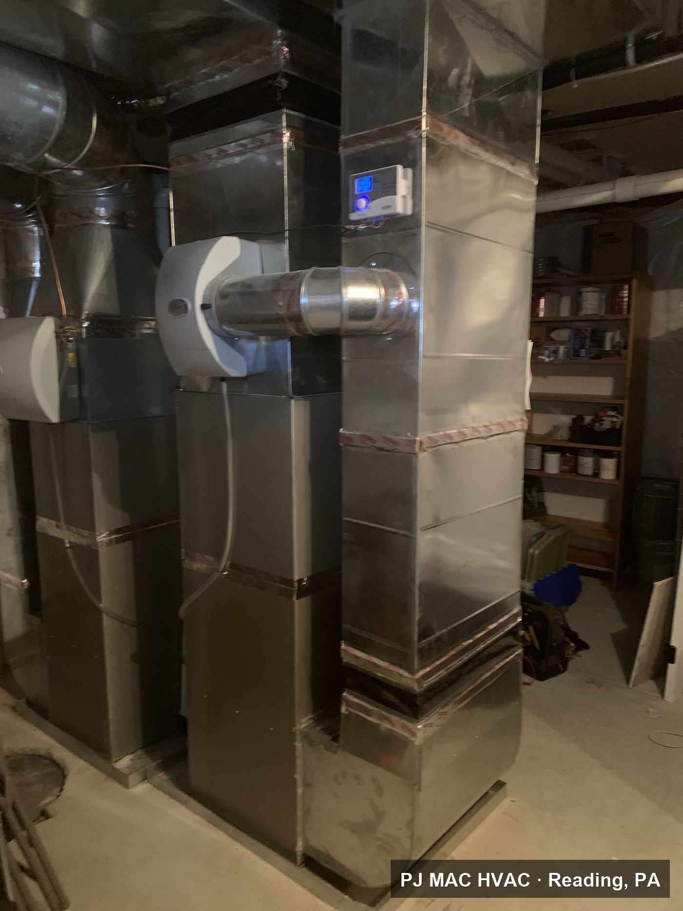 New furnace ductwork and a whole-house humidifier installed by PJ MAC HVAC in a basement.