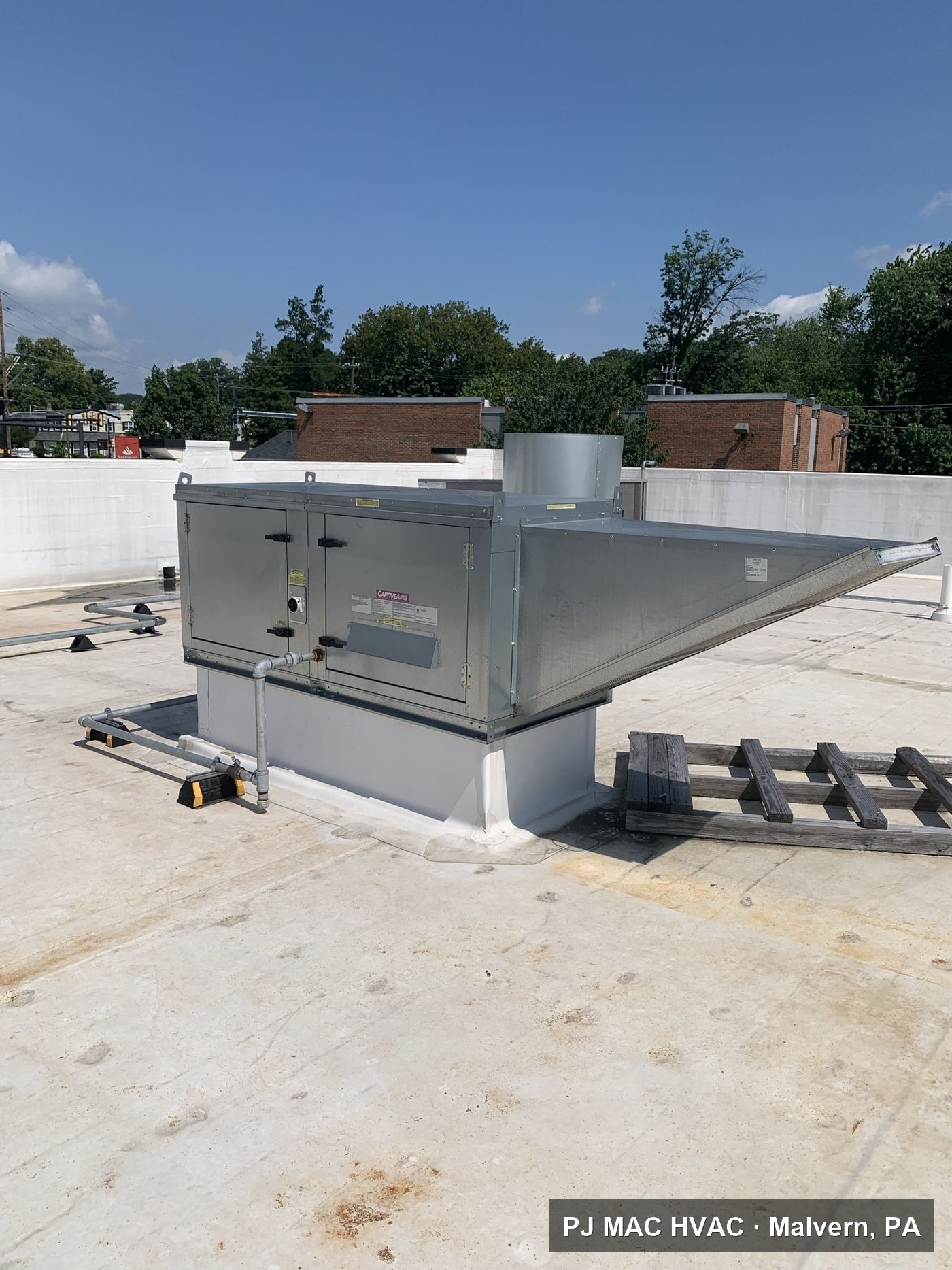 A commercial makeup air unit installed by PJ MAC HVAC on a flat roof.