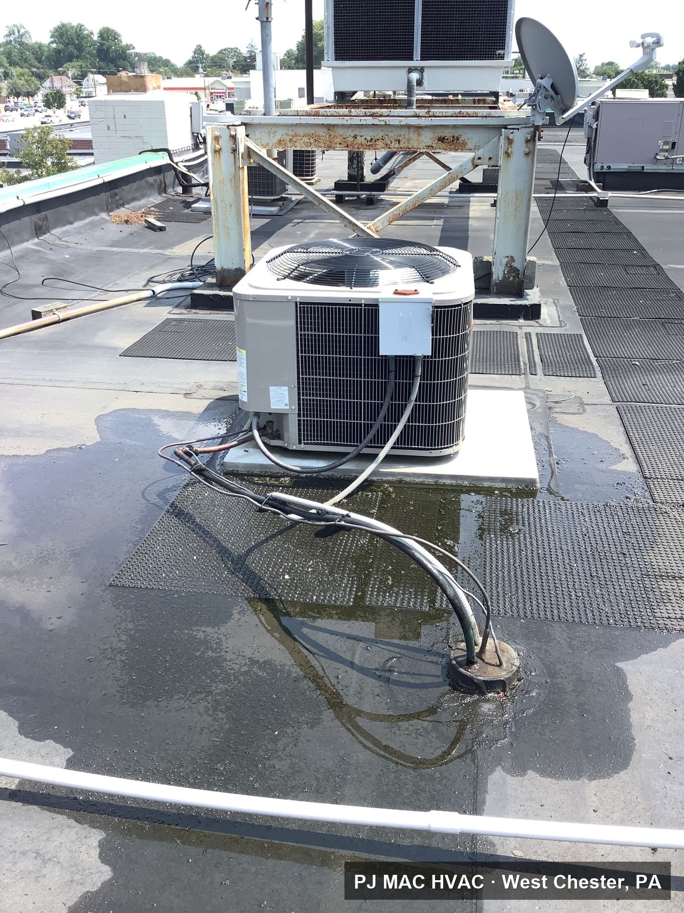 PJ MAC HVAC installed this AC condensing unit on the flat roof of a commercial building.