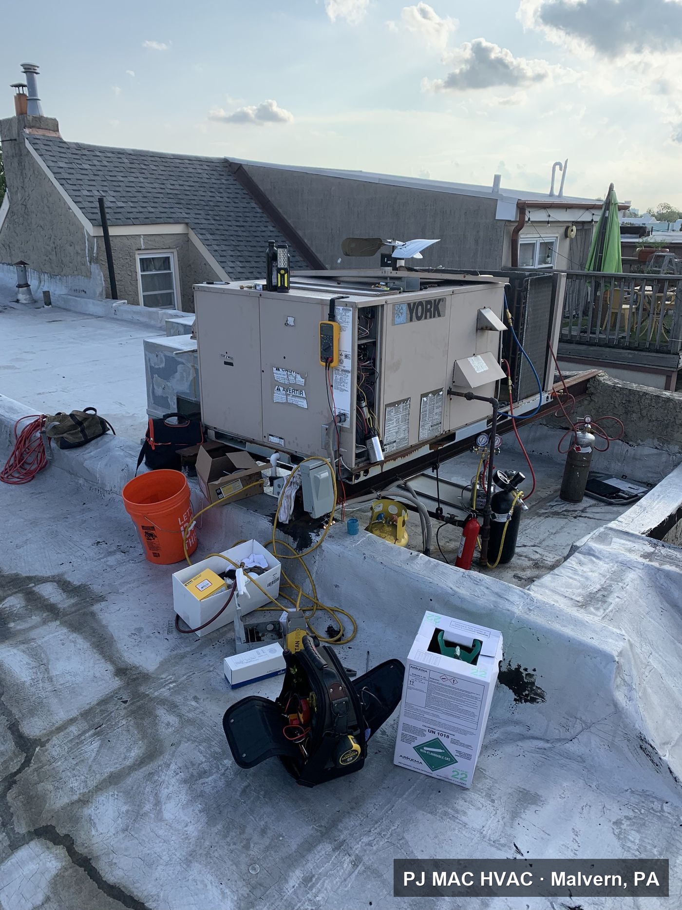 PJ MAC HVAC services a York packaged rooftop unit with refrigerant equipment staged on a flat roof.